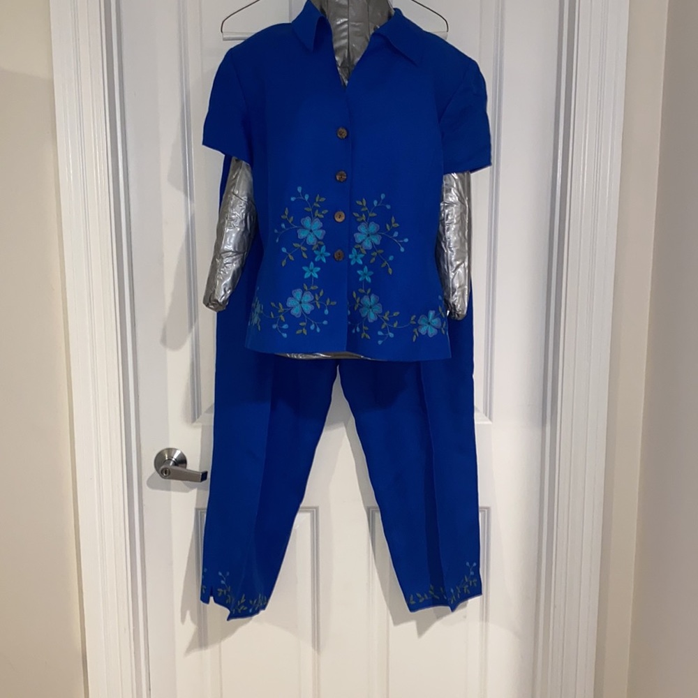 Blue pant suit with embroidered flowers.